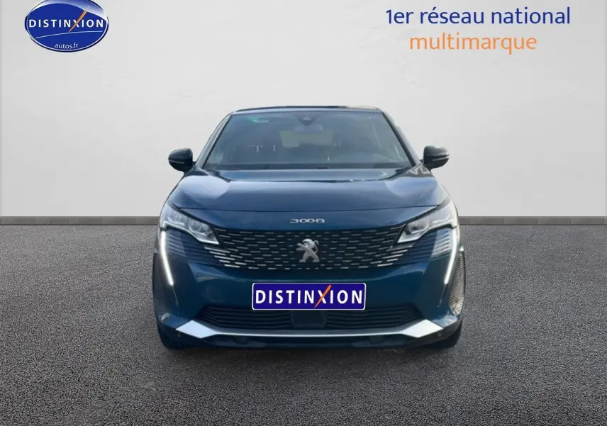Vue frontale d’un Peugeot 3008 bleu 2024 avec calandre chromée et feux LED allumés.