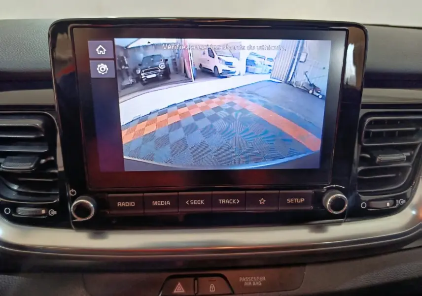 Vue rapprochée de l’écran tactile central du Kia Stonic gris clair 2022 affichant la caméra de recul avec guidage.