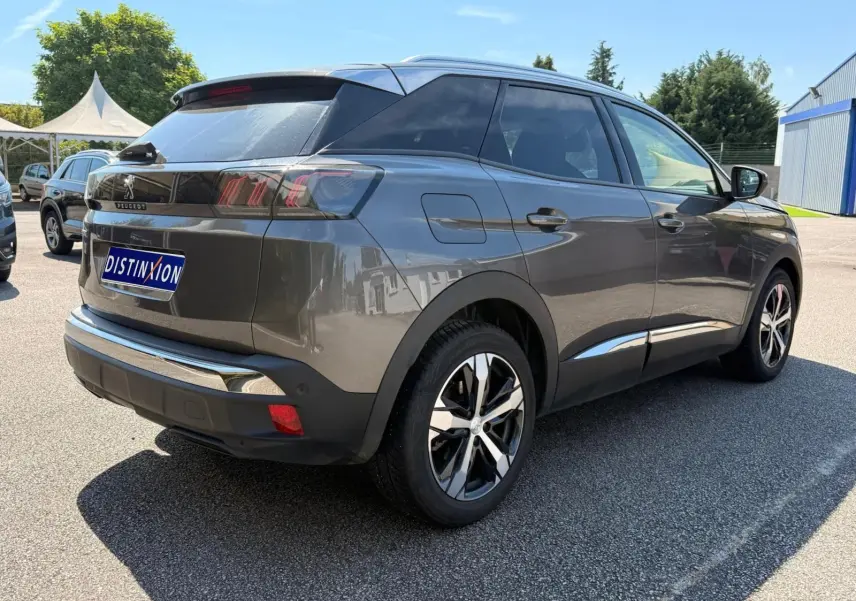 Peugeot 3008 gris platinium en 3/4 arrière droit, avec jantes bi-ton et feux arrière LED caractéristiques.