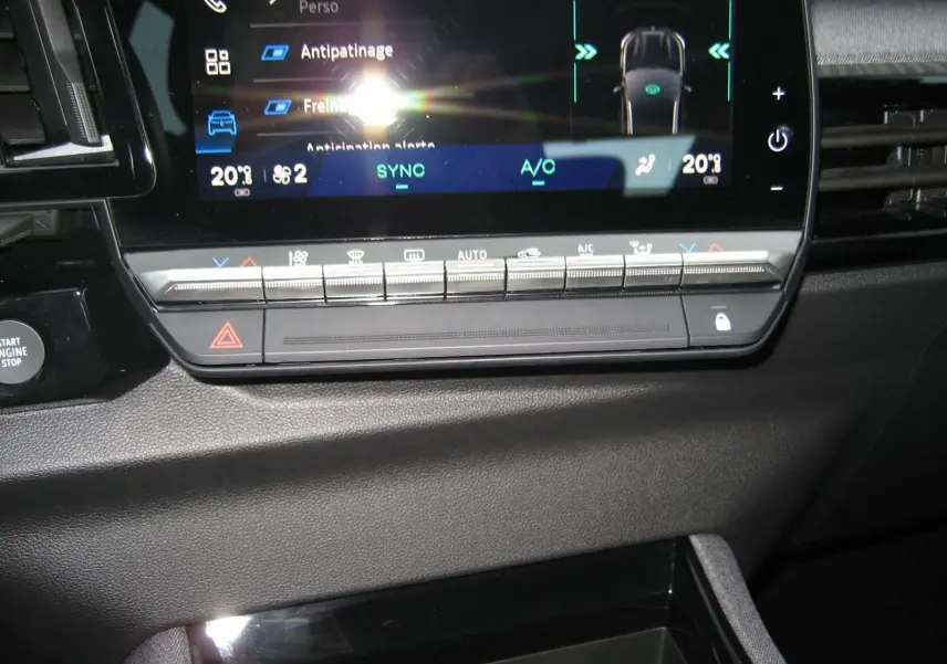 Détail de la console centrale du Renault Austral 2025, écran tactile et commandes climatisation visibles, intérieur noir.