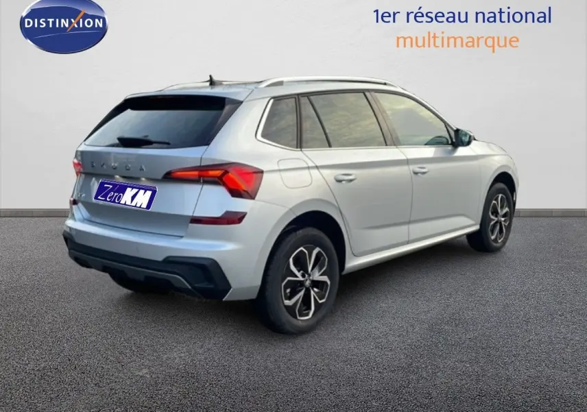 Vue 3/4 arrière droite d'un Skoda Kamiq gris argent métallisé avec jantes biton et vitres teintées.