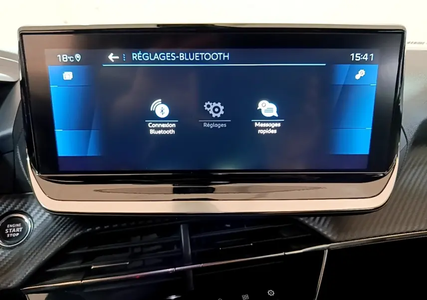 Écran tactile central affichant les réglages Bluetooth sur le tableau de bord carbone du Peugeot 2008 gris clair.