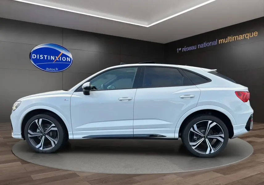 Audi Q3 Sportback blanc vue de profil côté gauche avec jantes sport noires et toit panoramique.
