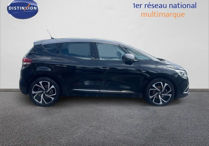 Profil côté gauche d’un Renault Scénic IV noir de 2017 avec jantes alliage au design moderne sur fond neutre.
