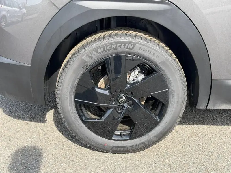 Gros plan sur la roue arrière droite du Citroën C5 Aircross gris Platinium avec jante noire brillante et pneu Michelin.