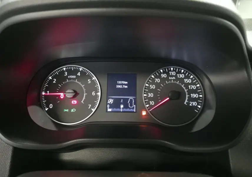 Vue rapprochée du tableau de bord du Dacia Duster 2024 montrant les compteurs analogiques et l'écran central numérique.