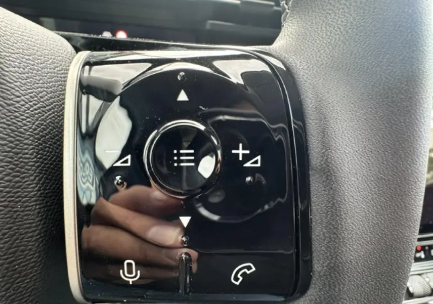Gros plan sur les commandes noires du volant du Citroën C5 Aircross gris Platinium, avec boutons de volume et appel.