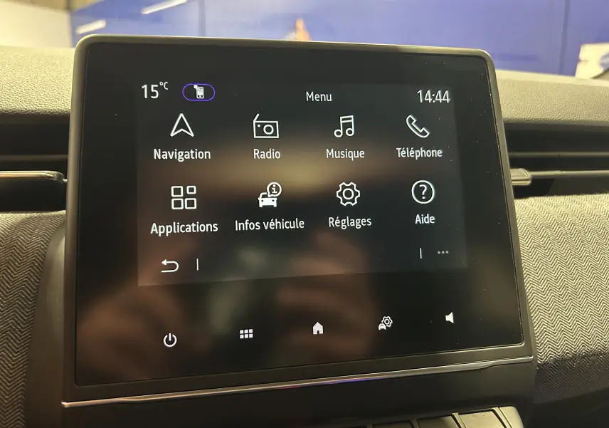 Écran tactile central de la Renault Clio V gris Rafale affichant le menu principal avec navigation et radio.