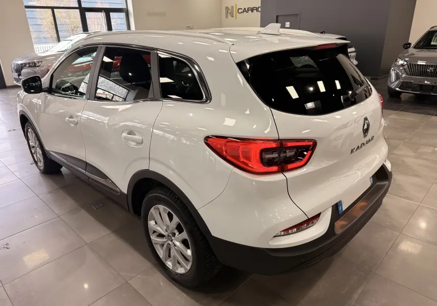 Vue 3/4 arrière droite d'un Renault Kadjar blanc Glacier 2020 en intérieur, avec feux arrière LED et jantes alliage.