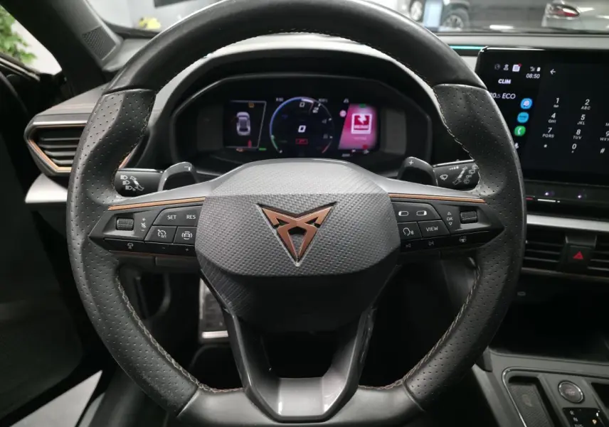 Vue rapprochée du volant sport en cuir noir avec logo Cupra cuivre et tableau de bord digital du Formentor 1.4 e-Hybrid 2023.