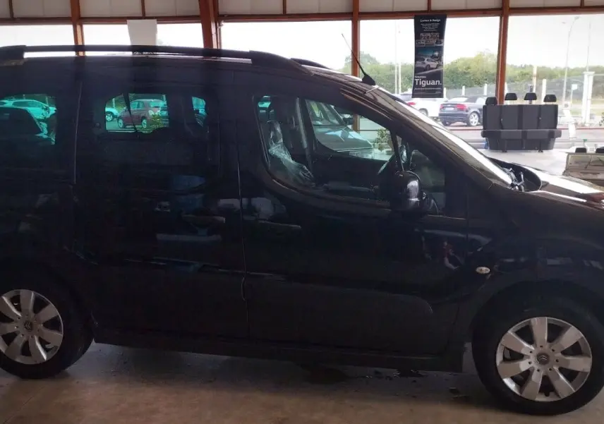 Profil côté gauche d'un Citroën Berlingo noir 2016 diesel, 5 places, avec jantes alliage et barres de toit visibles.