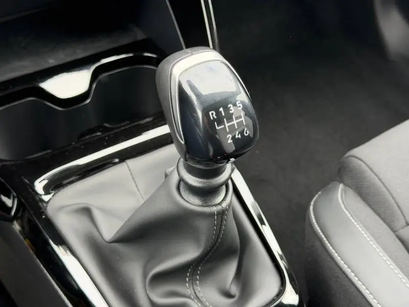 Gros plan sur le levier de vitesses manuel noir de la Citroën C3 1.2 Turbo 100ch MAX, intérieur tissu gris.