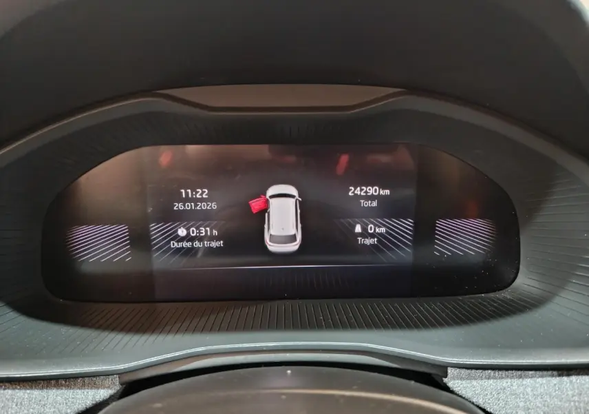 Affichage numérique du tableau de bord du Skoda Kamiq rouge, montrant l'alerte porte ouverte côté gauche.