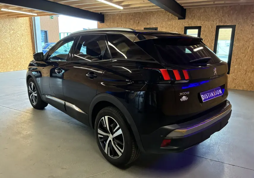 Vue 3/4 arrière droite d'un Peugeot 3008 noir 2020 avec feux arrière à griffes et jantes alliage bicolores.