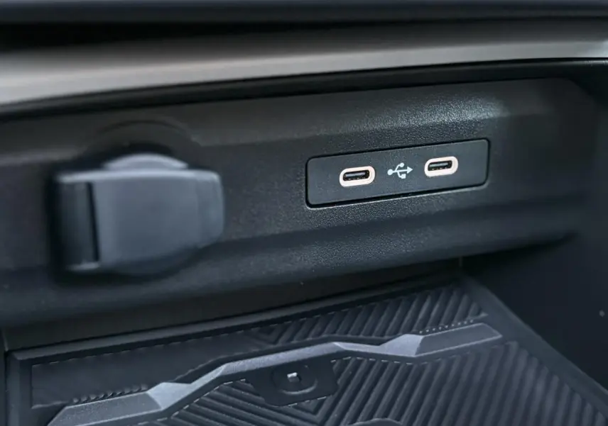 Gros plan sur les ports USB-C et prise 12V dans l'habitacle du Dacia Bigster noir nacré 2026.
