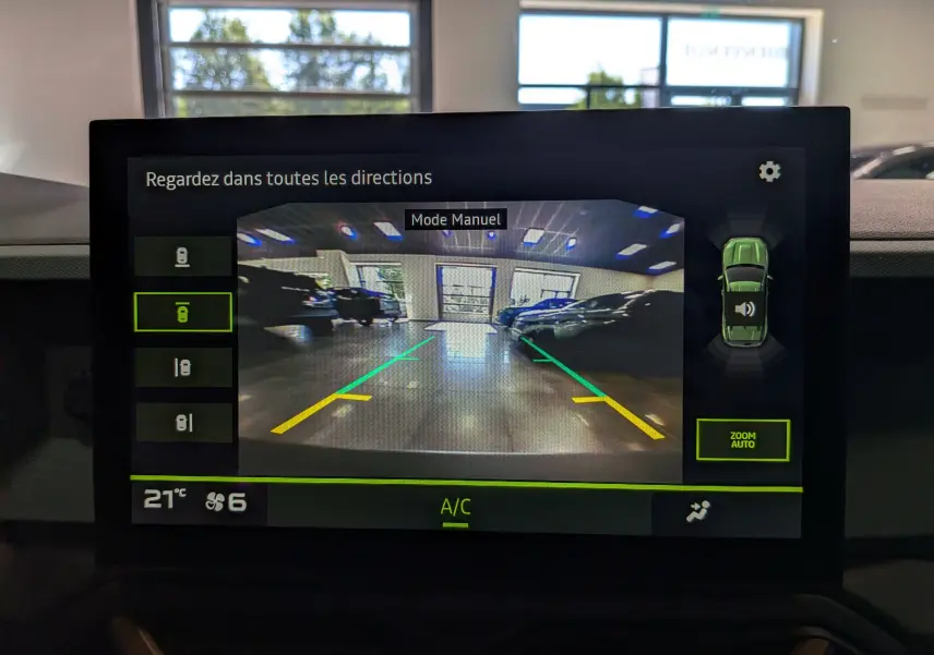 Écran de caméra de recul du Dacia Duster gris schiste, vue arrière avec lignes de guidage vertes et jaunes en intérieur.