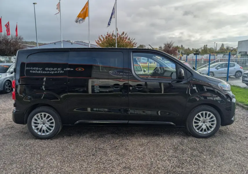 Profil côté gauche d'un Peugeot Expert Fourgon noir 2025 avec portes coulissantes et jantes tôles argentées.