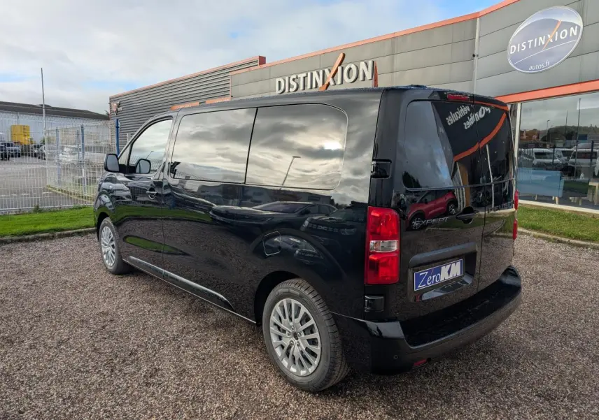 Vue 3/4 arrière droite du Peugeot Expert Fourgon noir 2025 avec vitres teintées et jantes tôle argentées.