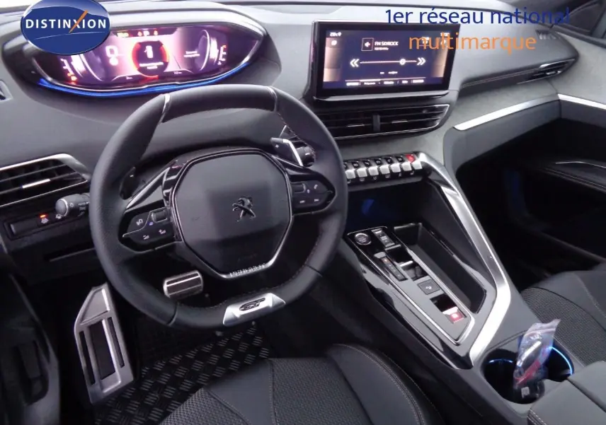 Intérieur de Peugeot 3008 GT 2023 en vue cockpit, volant compact, écran tactile et console centrale moderne noire.