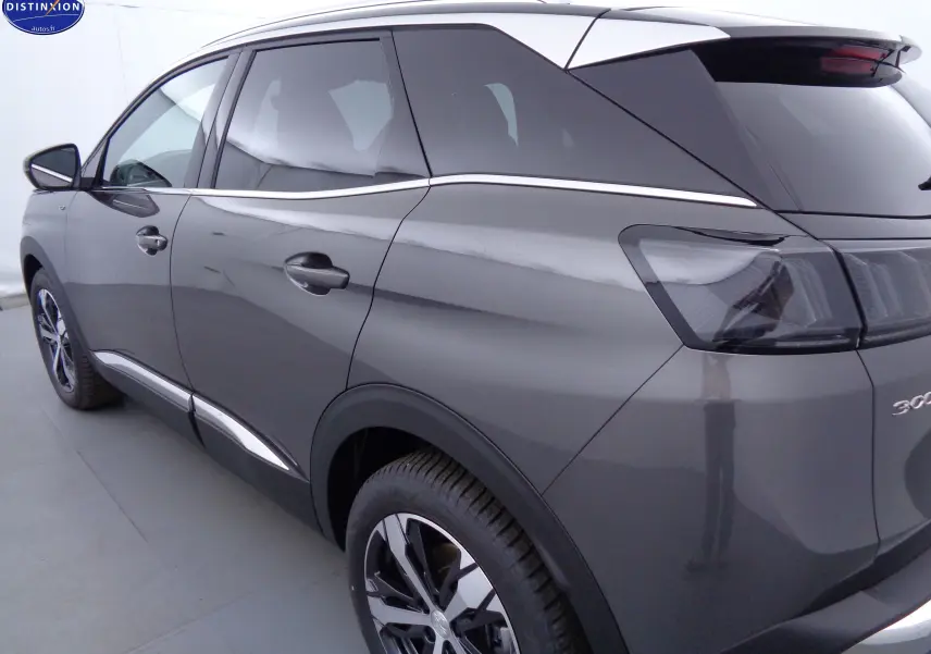 Vue 3/4 arrière côté gauche d'un Peugeot 3008 gris platinium métallisé avec jantes bi-ton et vitres teintées.