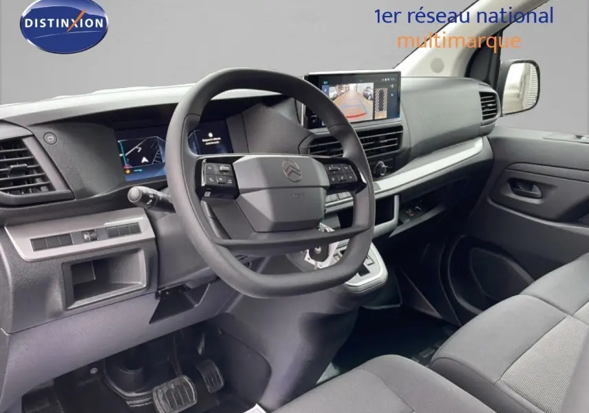 Vue intérieure côté conducteur du Citroën Jumpy gris Artense, tableau de bord moderne avec écran et volant multifonction.