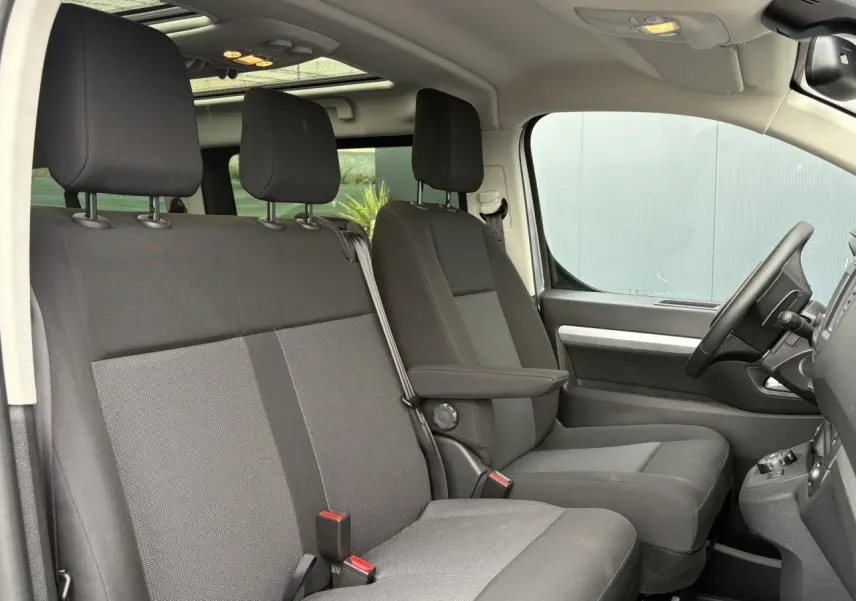 Intérieur avant de l'Opel Zafira Life XL gris, vue côté droit sur sièges tissu et toit panoramique lumineux.