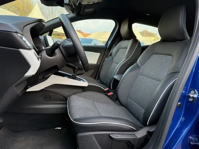 Vue intérieure côté gauche de la Renault Clio V 1.3 TCE 140 Intens 2022 bleu Iron, montrant les sièges avant et le volant.