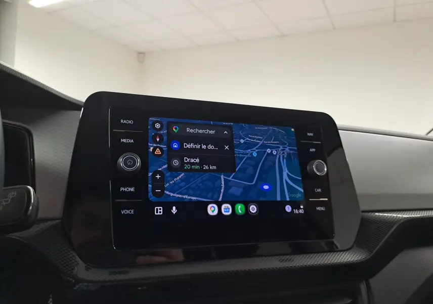 Écran tactile central du Volkswagen T-Cross 2025 affichant une navigation GPS, avec finition noire brillante autour.