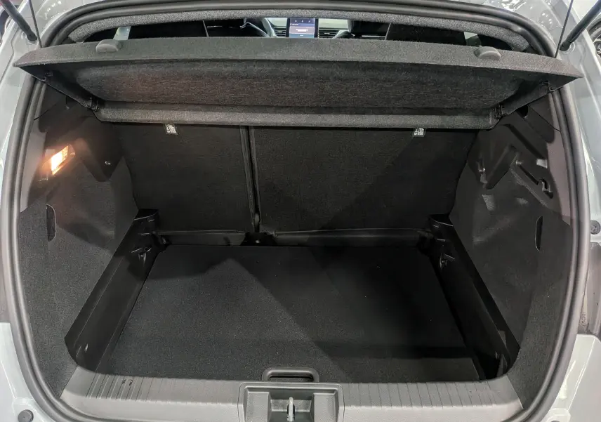 Coffre ouvert du Renault Captur gris rafale 2025, vue arrière montrant l'espace de chargement vide et l'éclairage intérieur.