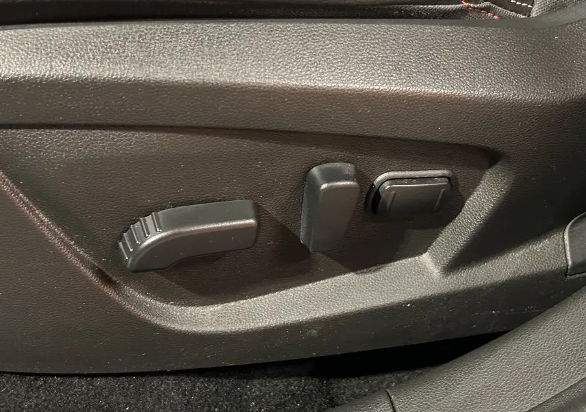 Gros plan sur les commandes électriques de réglage du siège avant noir du Renault Arkana E-Tech 145ch RS Line 2022.