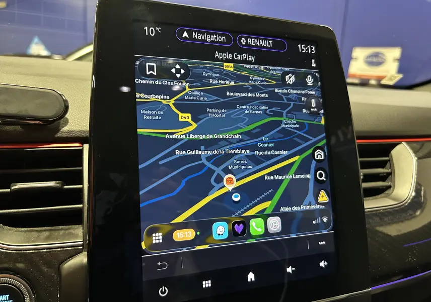 Écran tactile central du tableau de bord Renault Arkana E-Tech 2022 affichant la navigation Apple CarPlay.