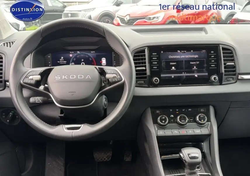 Vue intérieure du tableau de bord et volant cuir noir du Skoda Karoq 1.5 TSI 2025 avec écran tactile central.