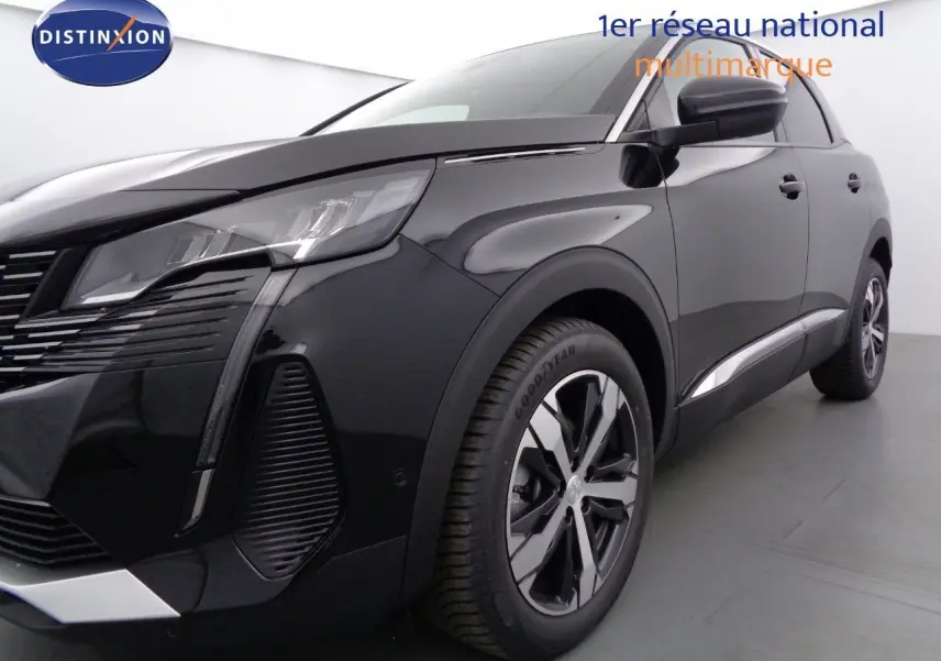 Gros plan sur la roue avant gauche et l'aile d'une Peugeot 3008 noire perle métal, soulignant la jante alliage moderne.
