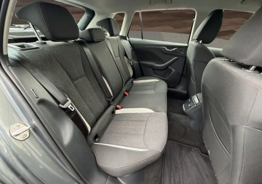 Vue intérieure arrière côté gauche du Skoda Kamiq 2023 gris foncé, montrant la banquette tissu et les portes.