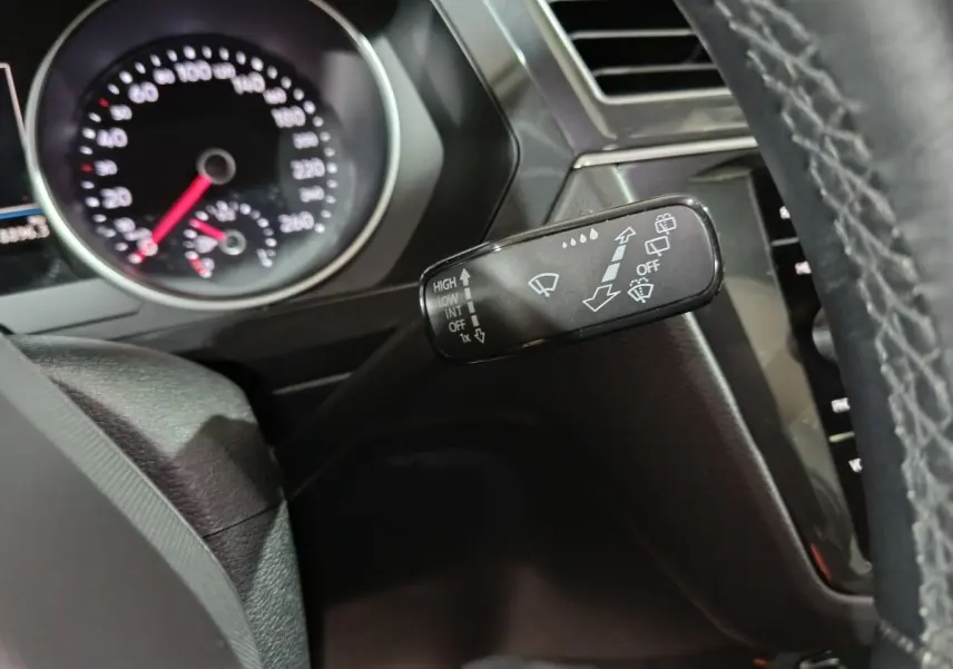 Gros plan sur la manette d’essuie-glace à gauche du volant cuir du Volkswagen Tiguan 1.5 TSI 2021.