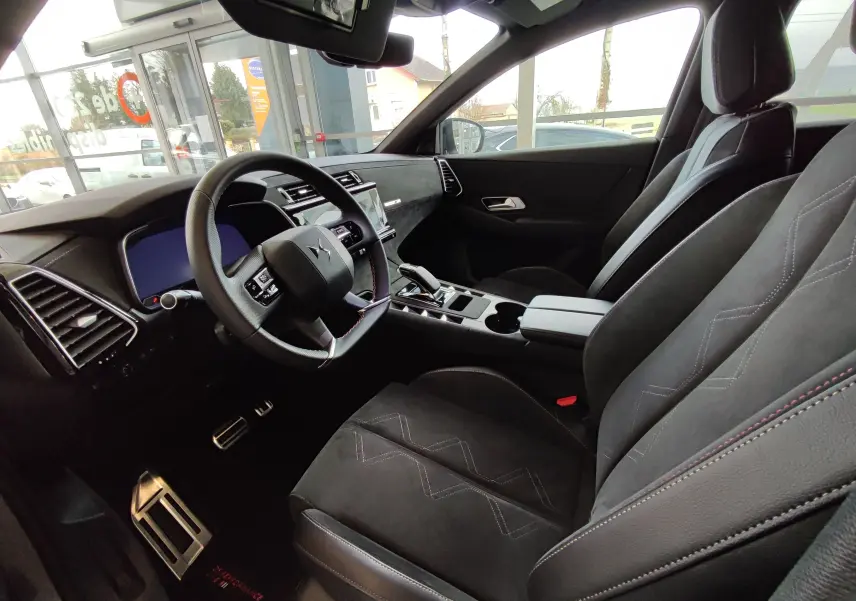 Vue intérieure côté conducteur du DS7 Crossback gris 2022, montrant le volant, les sièges en cuir et la console centrale moderne.