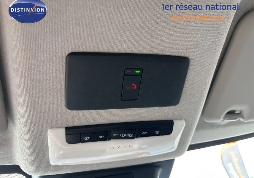 Vue intérieure du toit avec panneau de commandes et bouton SOS du Nissan Juke Hybrid gris Squale Metal 2024.