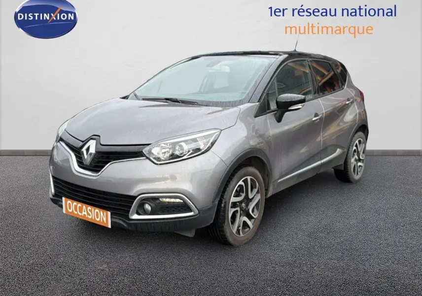 Renault Captur gris Cassiopée avec toit noir, vue 3/4 avant droit sur fond neutre, jantes alliage visibles.