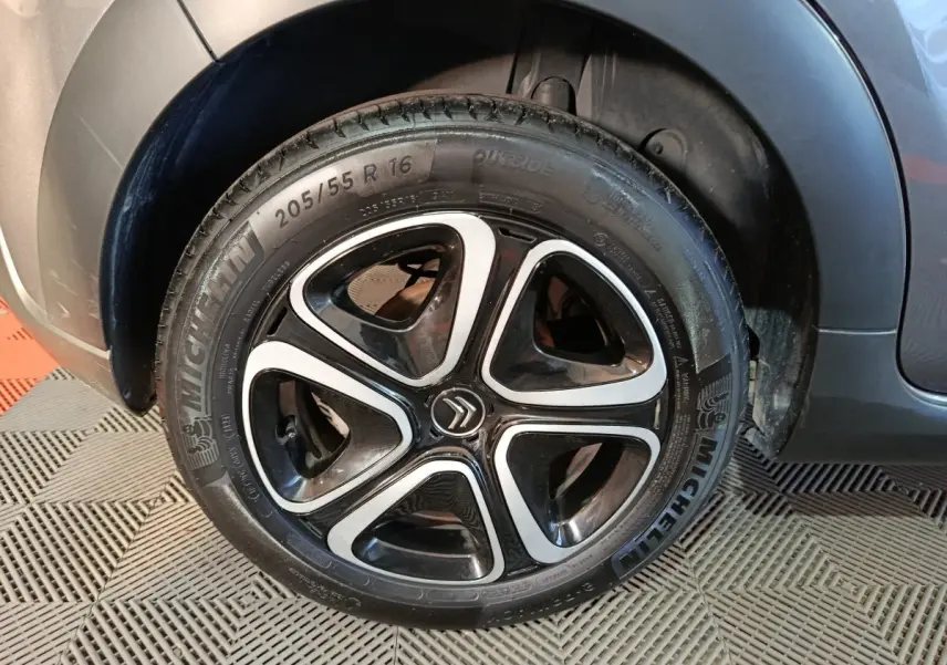 Gros plan sur la roue avant droite gris foncé d'une Citroën C3 2024 avec jante alliage noire et argentée.