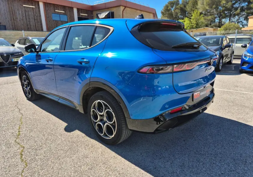 Vue 3/4 arrière droite d'une Alfa Romeo Tonale bleu 2025 avec jantes alliage 18 pouces et feux arrière allongés.