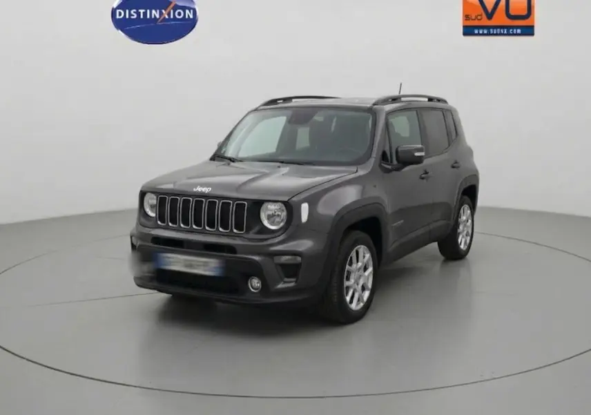 Jeep Renegade bleu foncé en 3/4 avant droit, avec barres de toit et jantes alliage 17 pouces visibles.