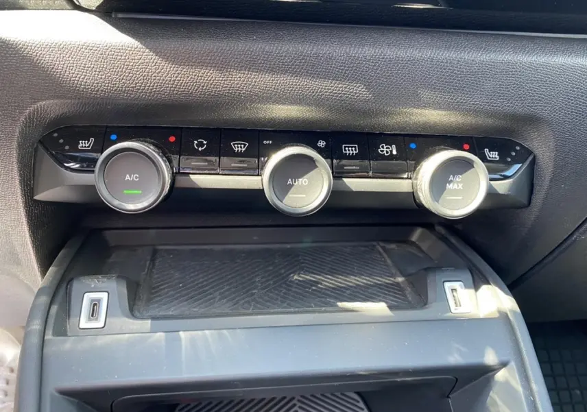 Vue rapprochée du tableau de bord du Citroën C4 2021 gris foncé, montrant les commandes de climatisation automatique.