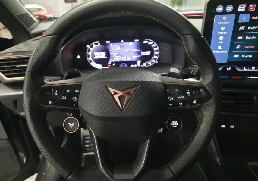 Volant cuir perforé noir avec logo CUPRA cuivré, tableau de bord digital et écran tactile central du Cupra Formentor 2025.