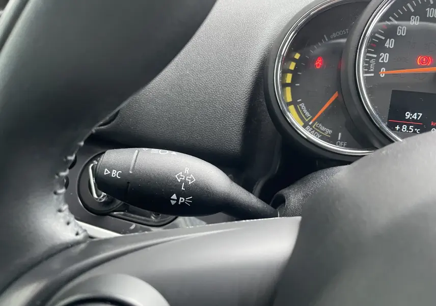 Gros plan sur le commodo de clignotant et le compteur du tableau de bord d'une MINI Countryman bleu Island Metal.