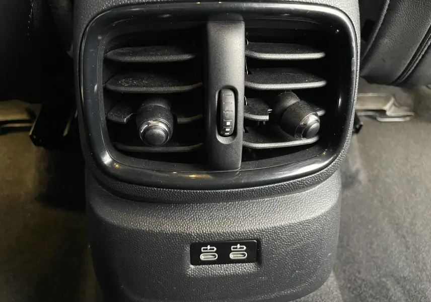 Gros plan sur la sortie d'air arrière noire et les deux ports USB du MINI Countryman hybride rechargeable.