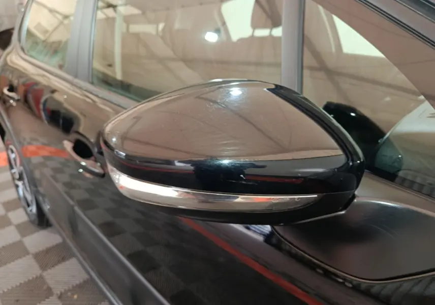 Gros plan sur le rétroviseur droit noir brillant de la Citroën C3 2024 avec clignotant intégré.