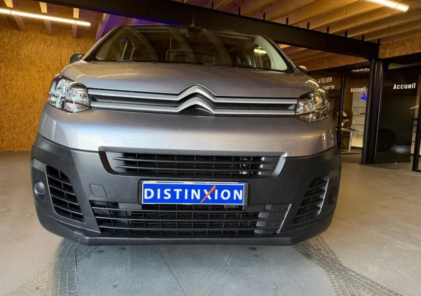 Vue frontale du Citroën Jumpy gris métallisé 2022 avec calandre noire et plaque d'immatriculation Distinxion.