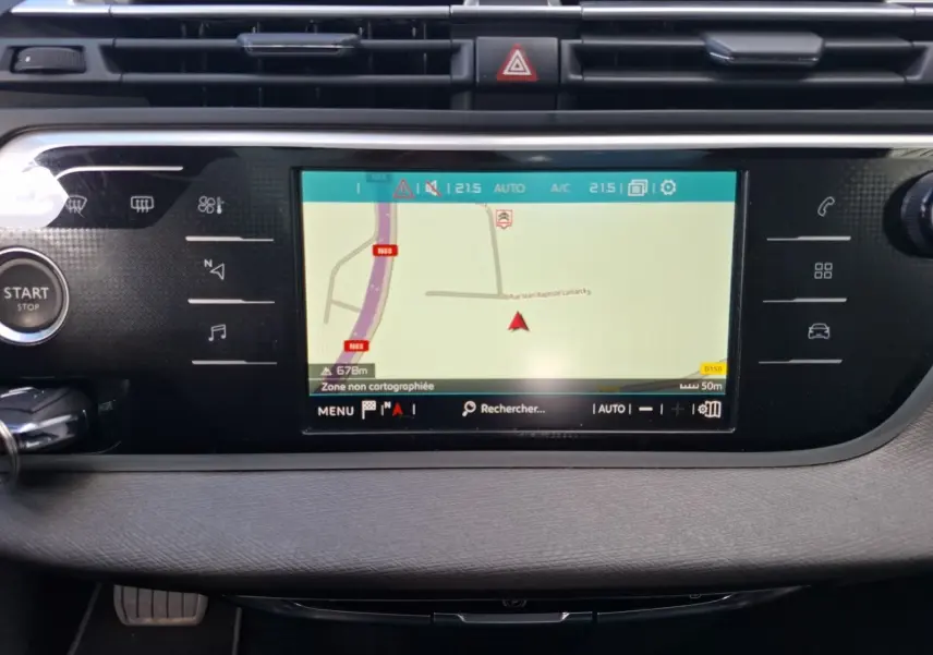 Vue rapprochée de l’écran tactile central du tableau de bord du Citroën C4 Picasso gris clair avec GPS intégré allumé.