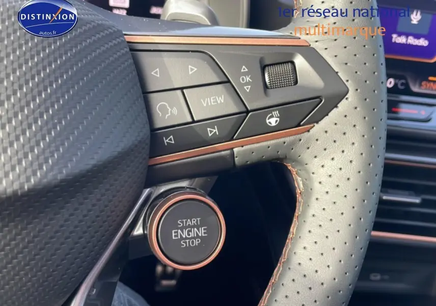 Gros plan sur le volant cuir perforé avec commandes multifonctions et bouton start/stop du CUPRA Formentor blanc Nevada.