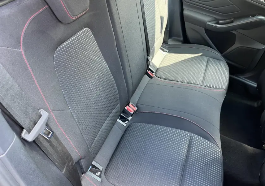 Vue intérieure des sièges arrière en tissu noir avec surpiqûres rouges d'une Ford Focus SW 2025, côté droit visible.